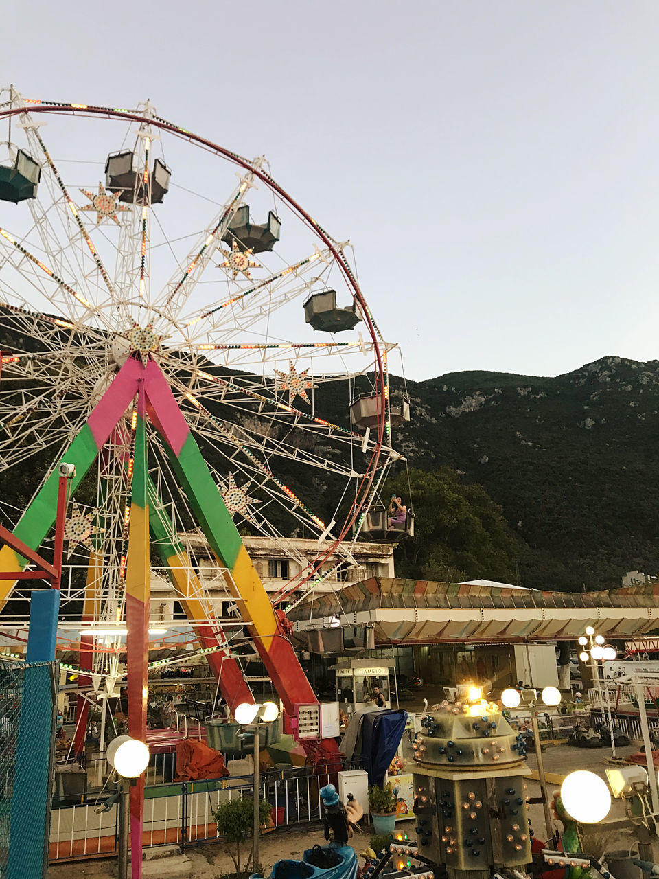 ILLUMINATED FERRIS WHEEL AGAINST SKY