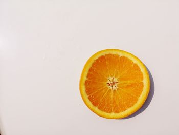 Close-up of orange slice against white background