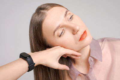 Portrait happy beautiful woman with bright orange lipstick, female hand touches