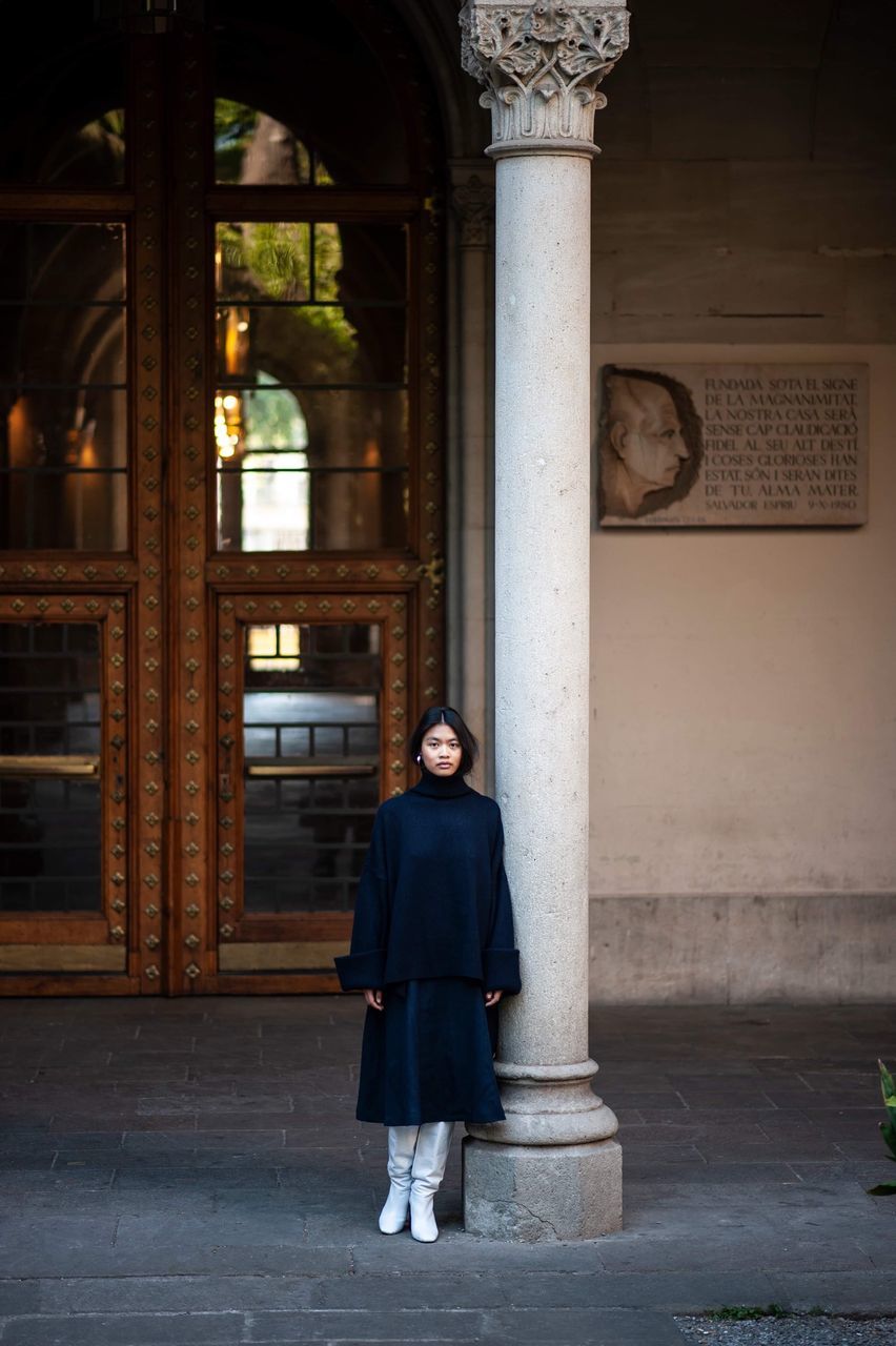 one person, full length, architecture, standing, architectural column, built structure, adult, real people, women, building exterior, day, building, front view, looking at camera, young adult, clothing, portrait, lifestyles, casual clothing, beautiful woman, outdoors