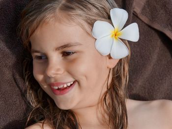 Portrait of smiling young woman holding flower