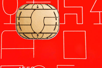 Close-up of basketball hoop against red wall