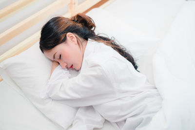 High angle view of woman sleeping on bed at home