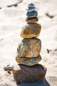 Close-up of chess stack on rocks at beach