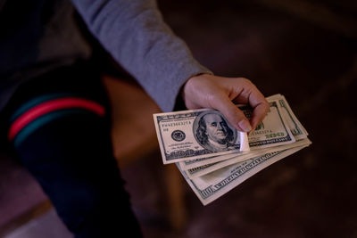 Midsection of person holding paper