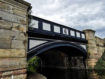 Low angle view of arch bridge against sky