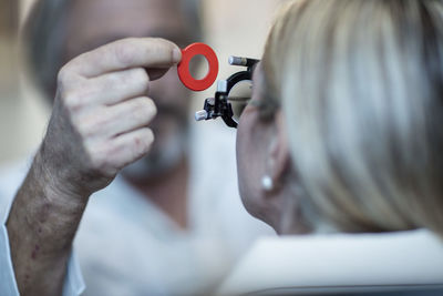 Optometrist adjusting test frame for patient