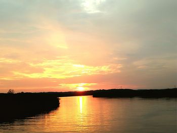 Scenic view of lake against romantic sky at sunset