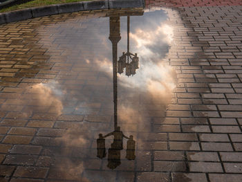 Reflection of buildings in puddle on street