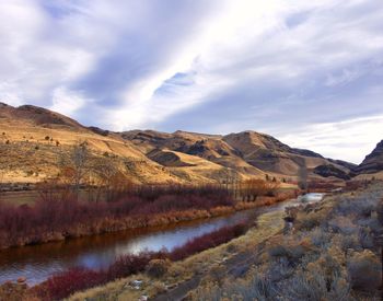 Scenic view of landscape and mountains against sky