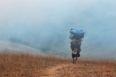 Porter carrying supplies uphill