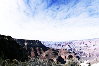 Scenic view of mountains against cloudy sky