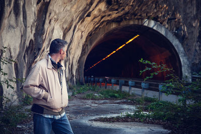 Man standing outside tunnel