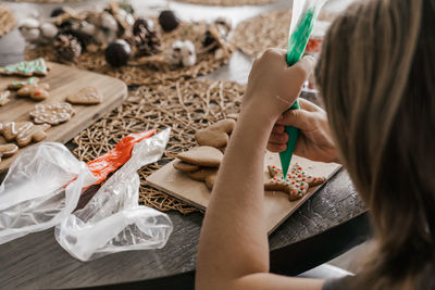 High angle view of girl decorating cookie