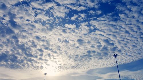 Low angle view of communications tower against sky during sunset