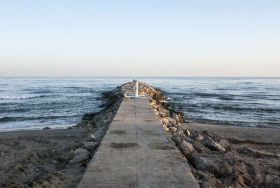 Pier over sea against clear sky