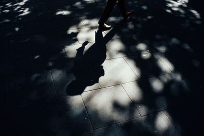 High angle view of woman walking on footpath