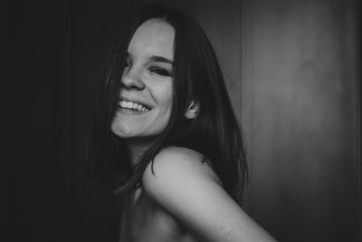 Portrait of smiling shirtless beautiful young woman