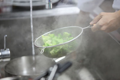 Midsection of man preparing food in kitchen