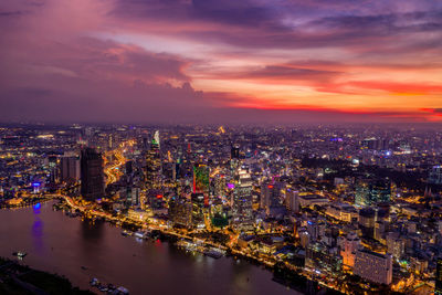 High angle view of illuminated buildings against sky at night