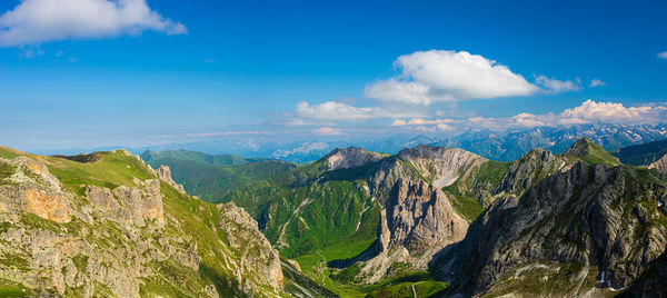 Panoramic view of mountains against blue sky