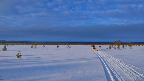 Scenic view of lake against sky during winter