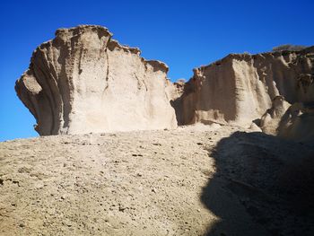 Low angle view of rock formations against sky