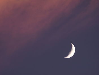 Low angle view of half moon against sky at night