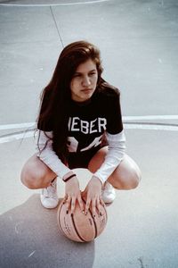 Young woman sitting on floor