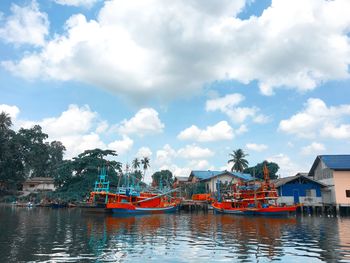 Boats moored in sea against sky