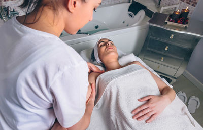 Midsection of woman lying on floor