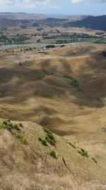 Scenic view of sand dunes against sky