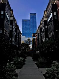 Street amidst buildings against sky in city
