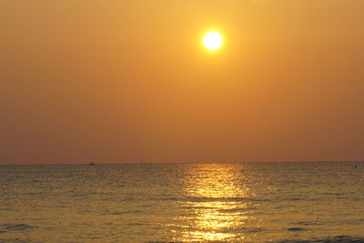 Scenic view of sea against orange sky
