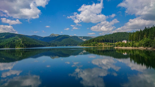 Scenic view of lake and mountains against sky