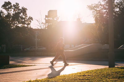 Portrait of child walking on the street during sunset