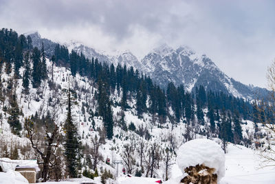 Scenic view of snow covered mountains against sky