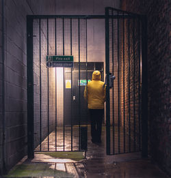 Rear view full length of woman standing in building corridor