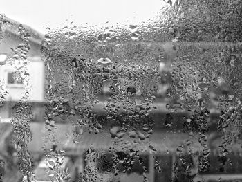 Full frame shot of wet glass window during rainy season