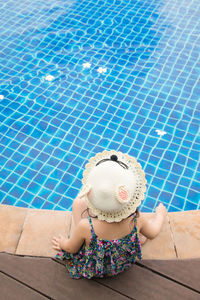 High angle view of woman sitting in swimming pool