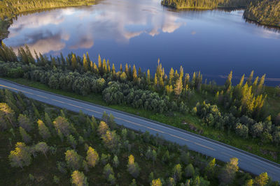 Scenic aerial norwegian nordland county lake side highway drive. scendinavian wilderness landscapes.