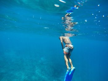 Young woman swimming in sea