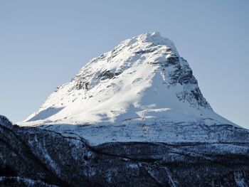 Low angle view of snowcapped mountain against sky