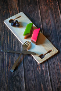 High angle view of multi colored pencils on cutting board