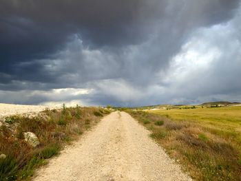 Empty road along countryside landscape