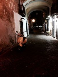 Illuminated tunnel at night