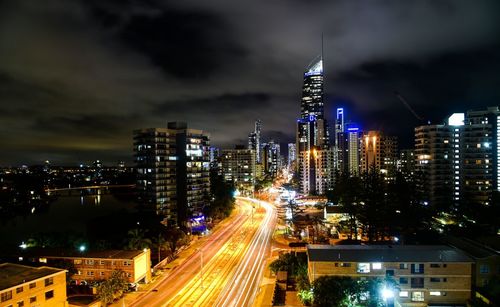 High angle view of light trails on road against buildings