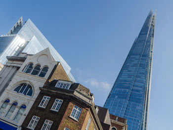 Low angle view of modern building against blue sky