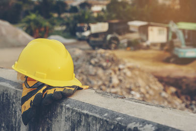 Close-up of hardhat and gloves on retaining wall