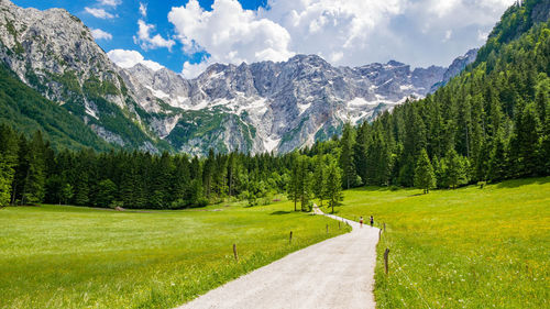 Empty gravel road in idyllic alpine valley. mountains, nature, spring, summer.